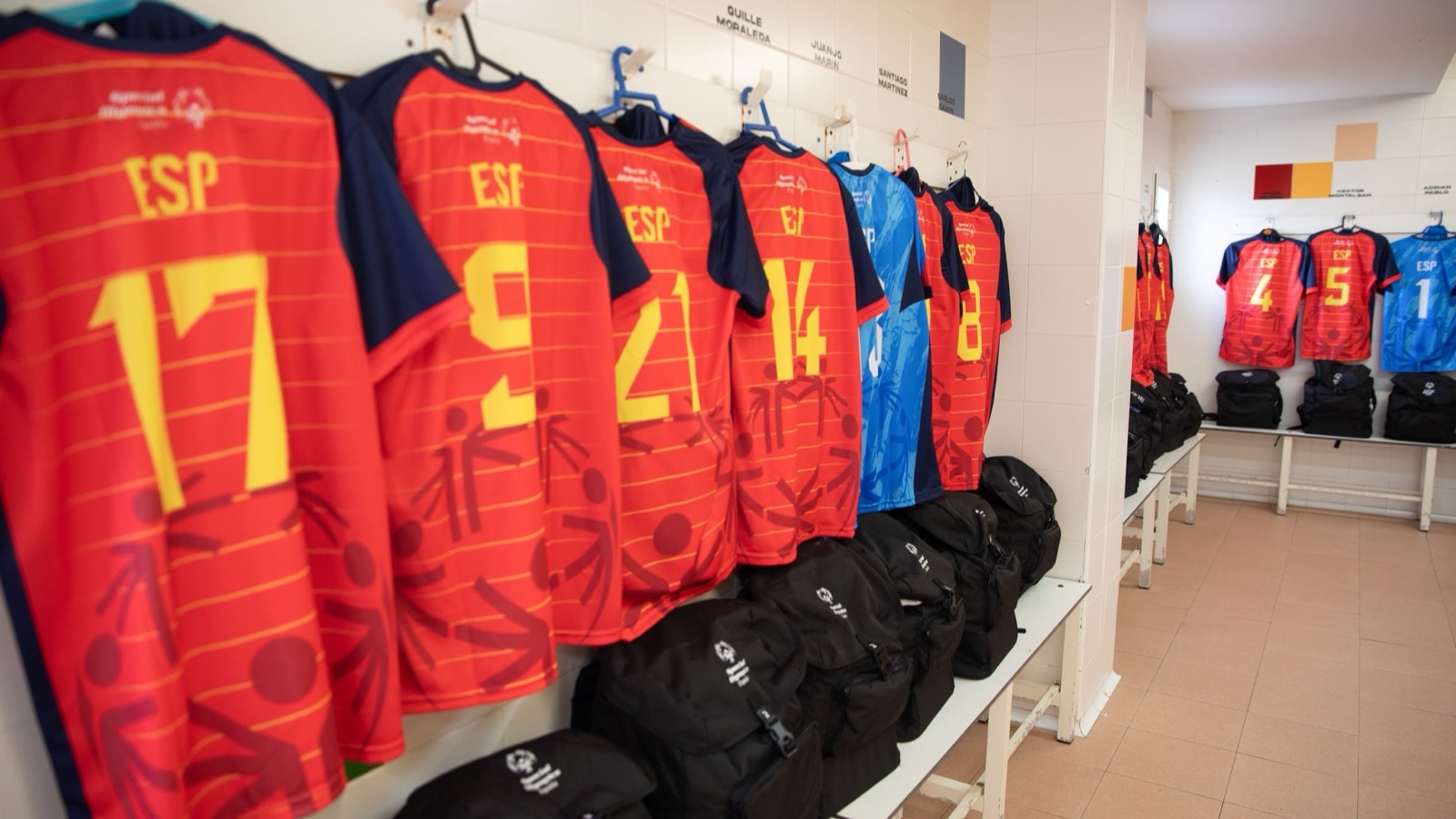 Spain's Special Olympics jerseys, numbered and marked ESP, hanging ready in the dressing room